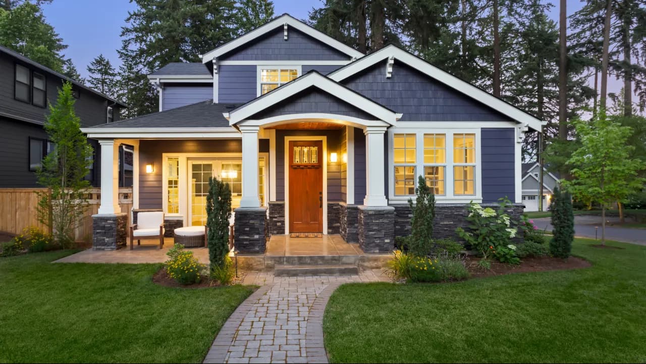Well-maintained suburban home with a stone walkway at twilight