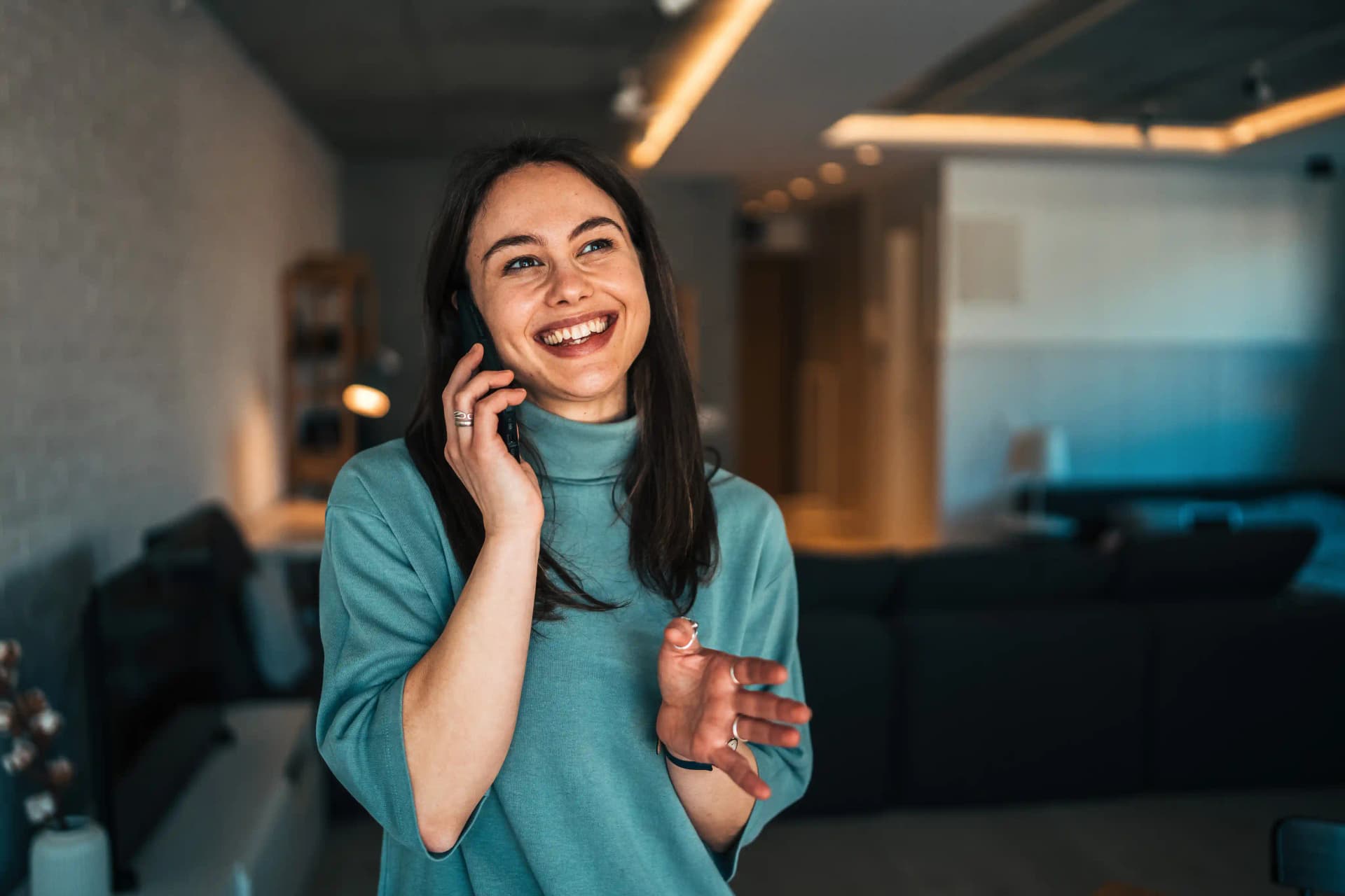 Homeowner smiling during a phone call with her mortgage servicer